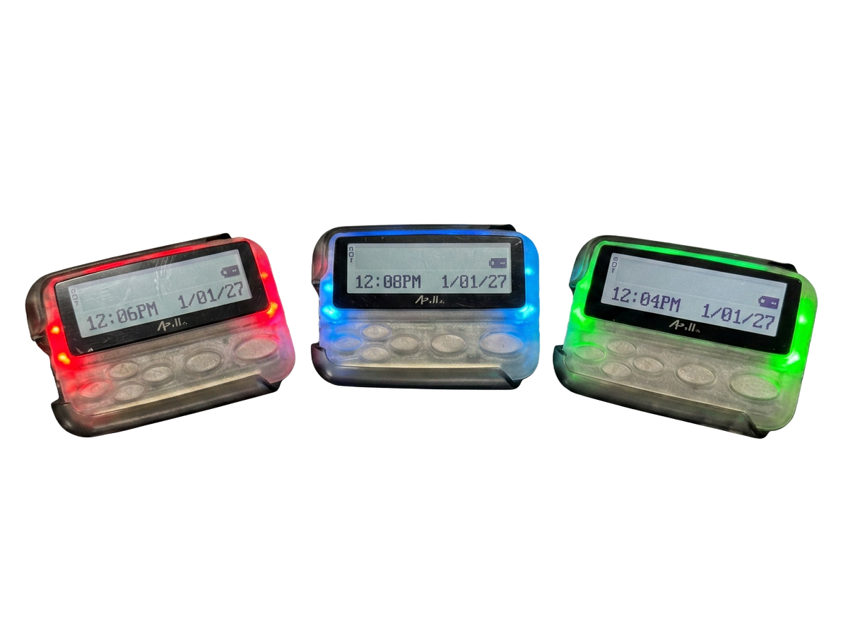 Three Apollo Wireless pagers with red, blue, and green status LEDs
